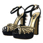 Schwarze und goldene Sandalen mit verzierten Absätzen