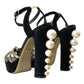Schwarze und goldene Sandalen mit verzierten Absätzen