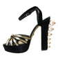 Schwarze und goldene Sandalen mit verzierten Absätzen