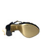 Schwarze und goldene Sandalen mit verzierten Absätzen