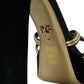Schwarze und goldene Sandalen mit verzierten Absätzen