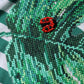 T-shirt girocollo con foglie a righe bianche e verdi