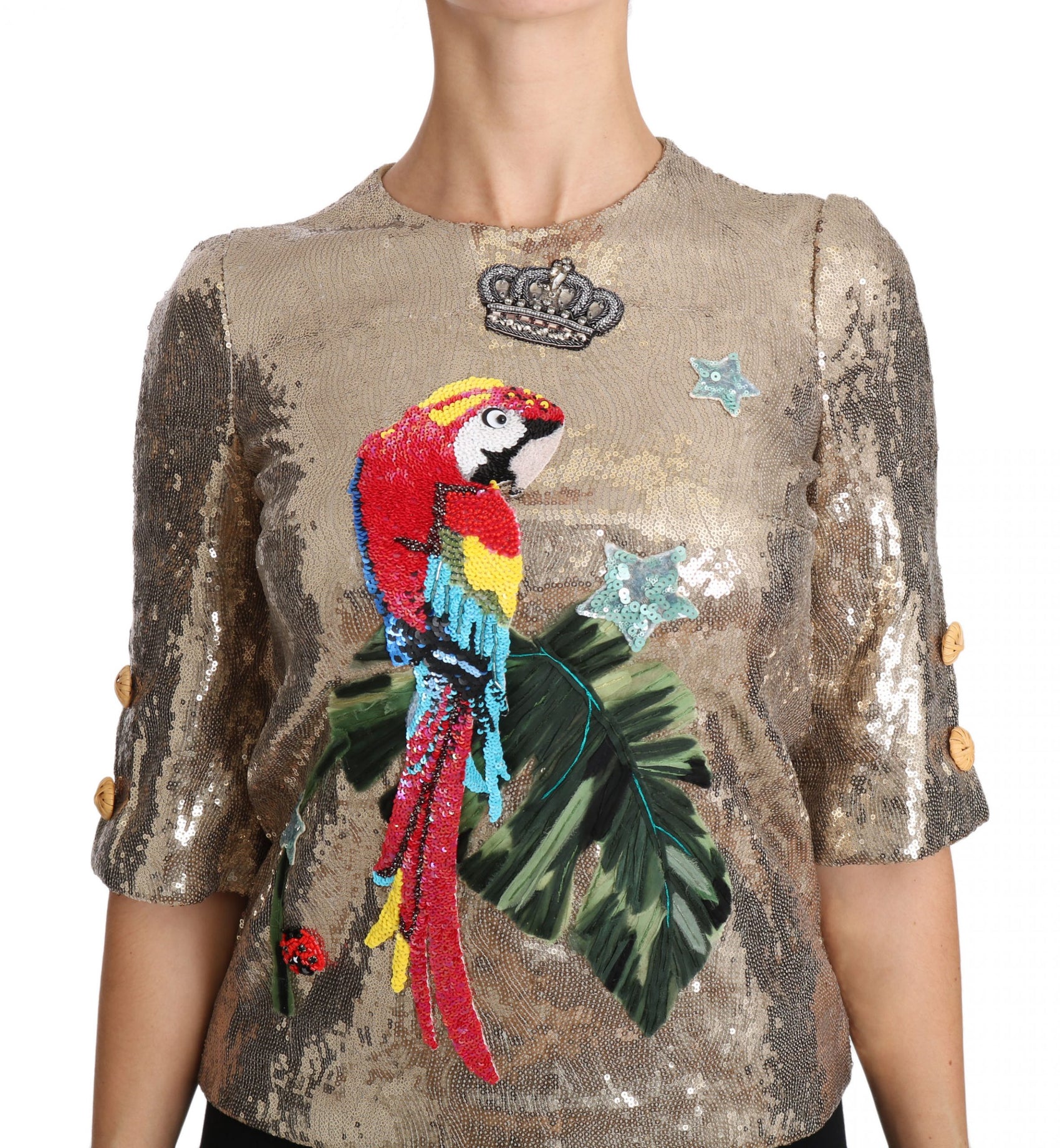 Rundhalsbluse mit goldenem Papageienmotiv und Kristallen